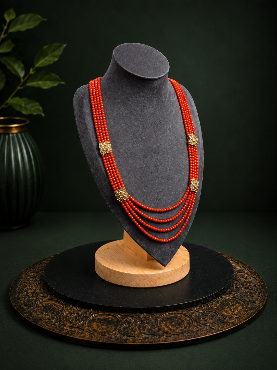 Coral red multi-strand floral beaded necklace shown from a left-angle view