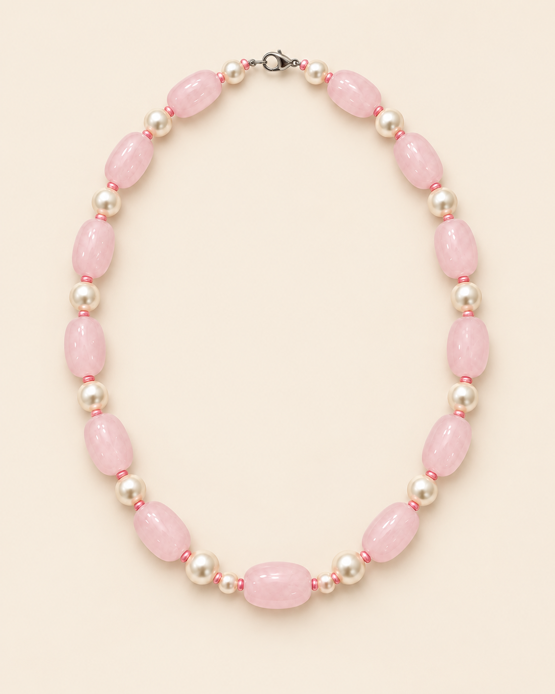 Blush pink oval beaded necklace with ivory accents and two small beads beside the centre bead – full view