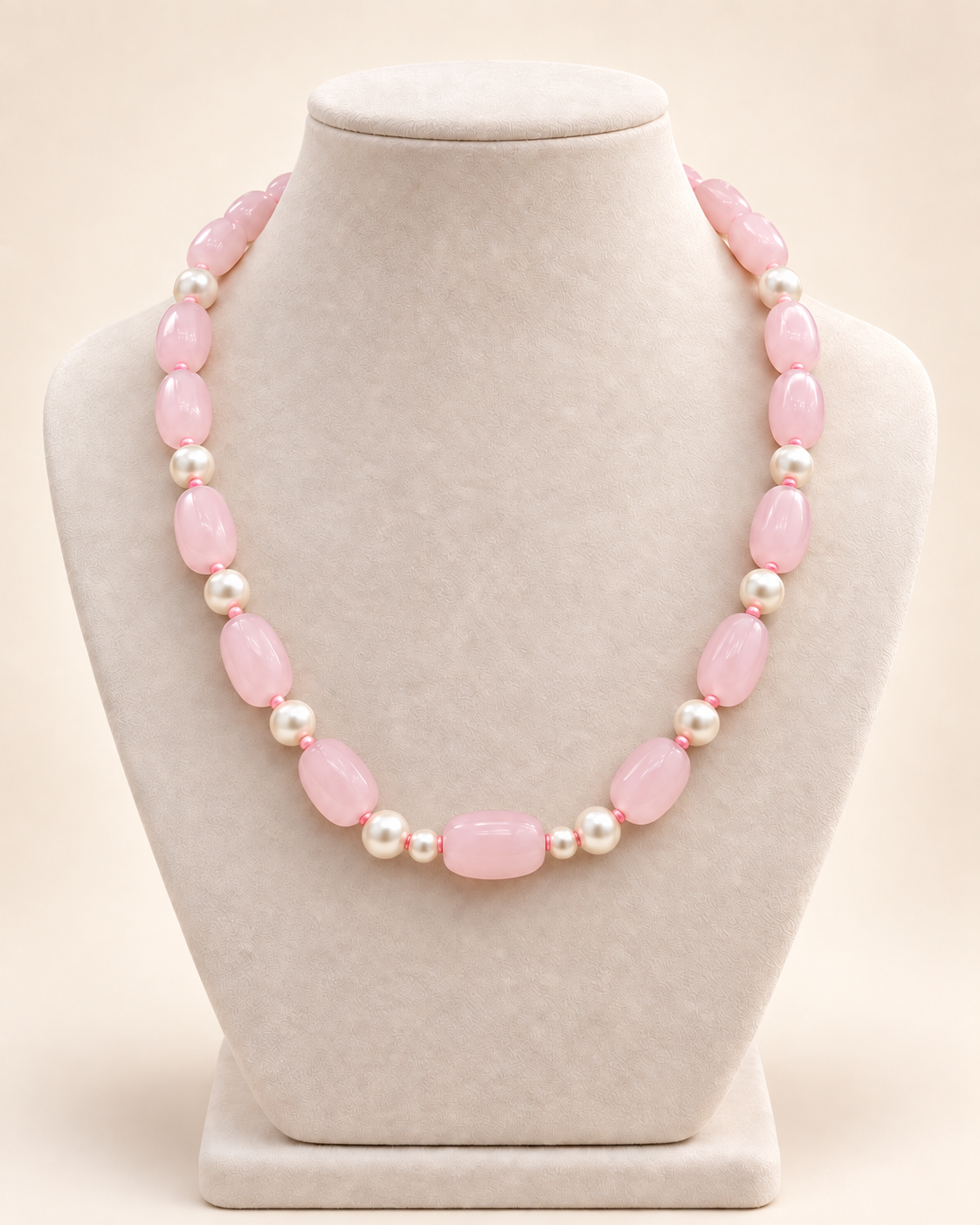 Blush pink oval beaded necklace with ivory accents and two small beads beside the centre bead – main view